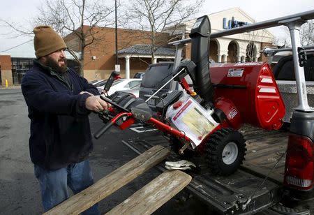 Corey Ihasz of Potomac, Maryland loads his new snow blower into his truck at the Lowe's store in Kentlands, Maryland January 21, 2016. REUTERS/Gary Cameron