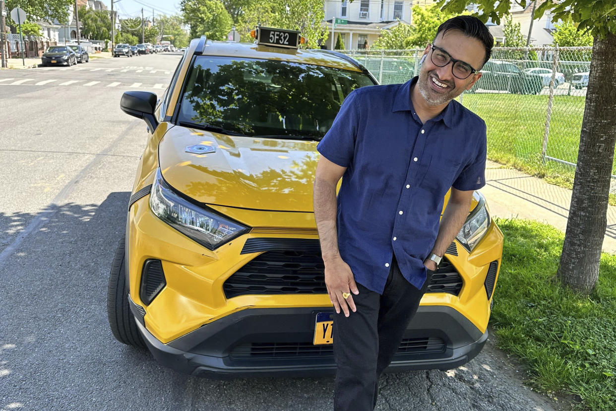 New York City cab driver Sukhcharn Singh poses for a photo with his taxi in the Queens borough of New York, Wednesday, May 17, 2023. Prince Harry and his wife, Meghan, were pursued in their car by photographers after a charity event in New York, Tuesday evening May 16, 2023. With the help of police, the couple was eventually able to switch to Singh's taxi cab and be whisked away, according to a law enforcement official who was not authorized to speak publicly about the matter and did so on condition of anonymity. (AP Photo/David R. Martin)