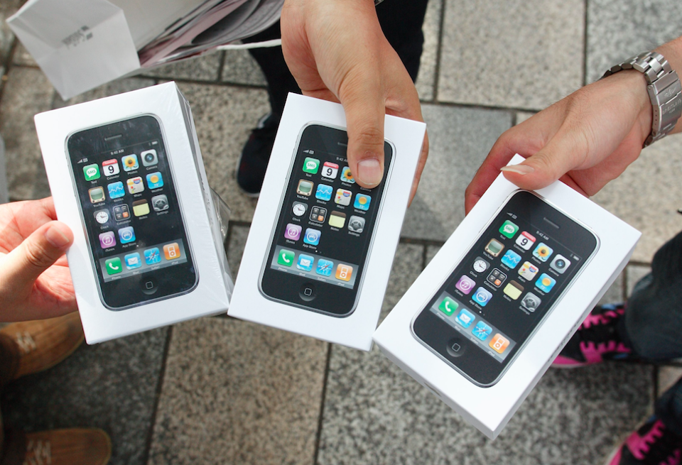 Three people show off their iPhone 3G purchases (Picture: Rex)