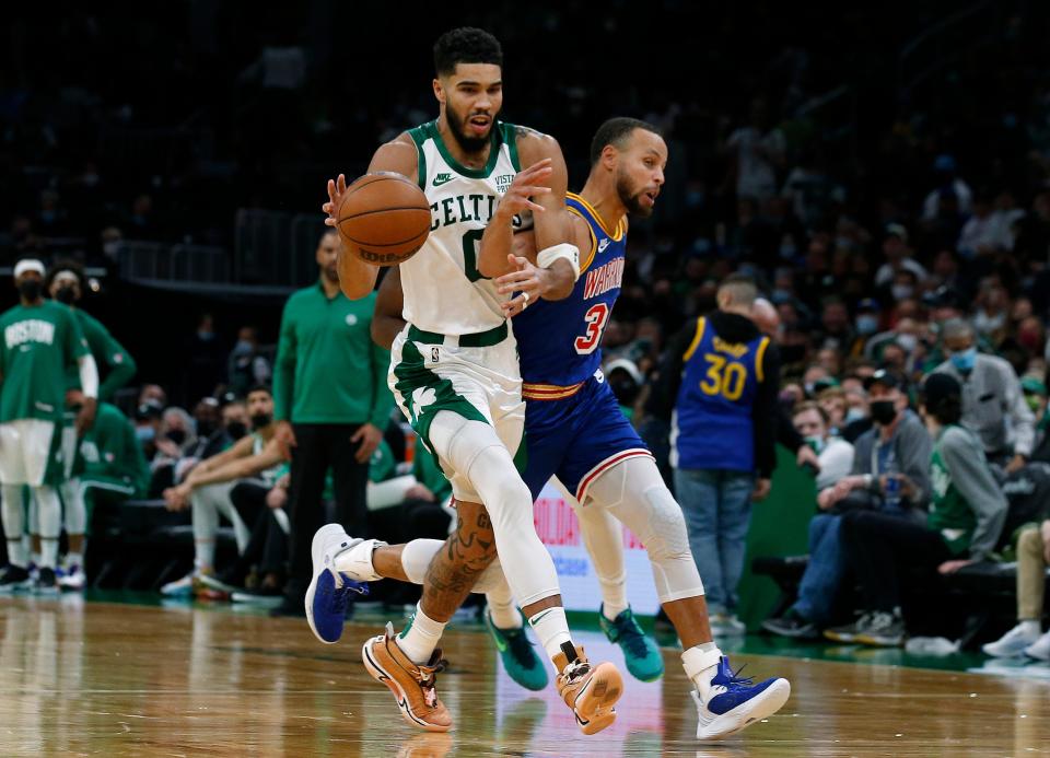 Celtics forward Jayson Tatum beats Warriors guard Stephen Curry  to a loose ball during the second half on Friday night.