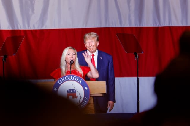 Former U.S. President Donald Trump looks on as Rep. Marjorie Taylor Greene (R-GA) speaks during his remarks at the Georgia state GOP convention at the Columbus Convention and Trade Center on June 10, 2023 in Columbus, Georgia.