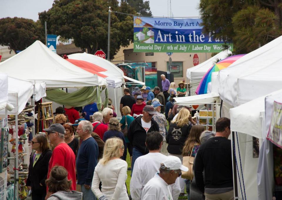 Visitors peruse arts and crafts at Morro Bay’s Art in the Park. The event returns July 2-4.