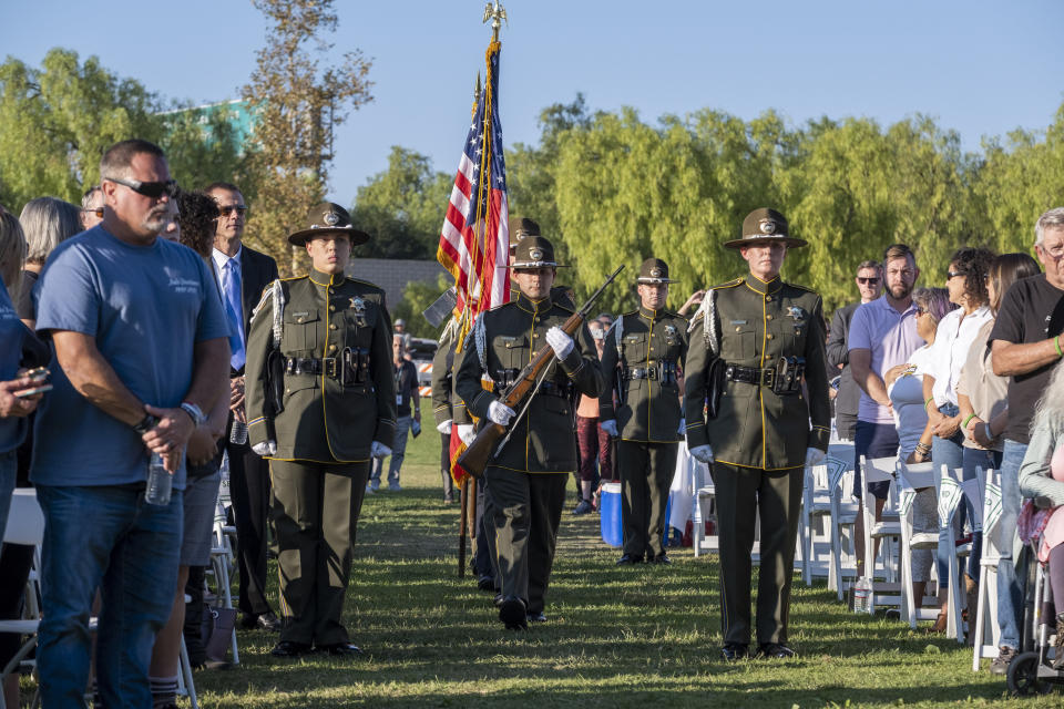 The Ventura County Sheriff's Department honor guard makes its way to the stage during the dedication of the Borderline Healing Garden at Conejo Creek Park in Thousand Oaks, Calif., Thursday, Nov. 7, 2019. The dedication marked the anniversary of a fatal mass shooting at a country-western bar a year earlier. (Hans Gutknecht/The Orange County Register via AP)