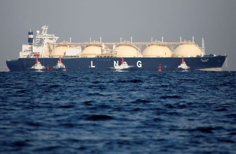 FILE PHOTO: An LNG tanker is tugged towards a thermal power station in Futtsu