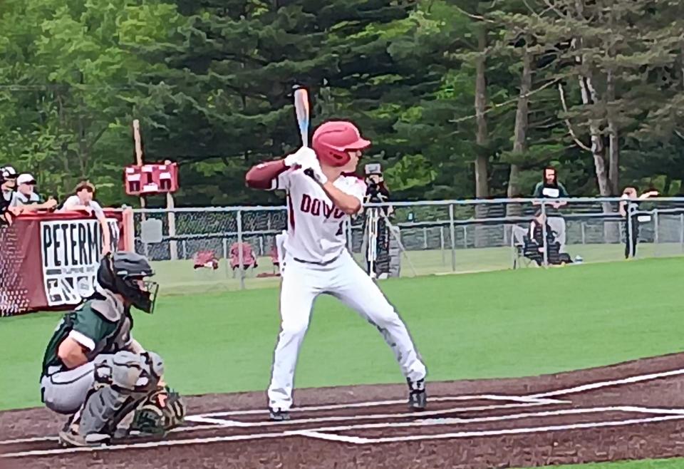 Dover High School leadoff hitter Caden Schie, right, awaits the pitch as Canton Central Catholic catcher Nick Hilton, left, looks on during Monday evening's high school baseball game at Dover City Park.