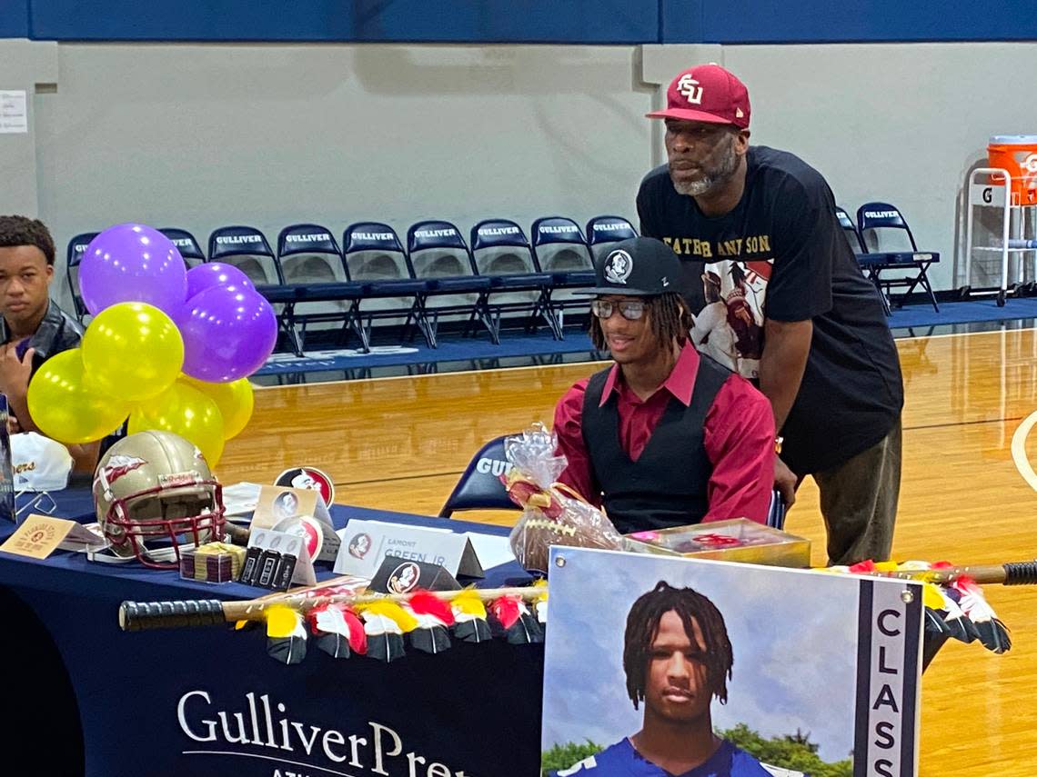 Gulliver Prep defensive end Lamont Green Jr. poses with his father, FSU great Lamont, Sr., before signing his letter of intent with the Seminoles on Wednesday at a ceremony at Gulliver.