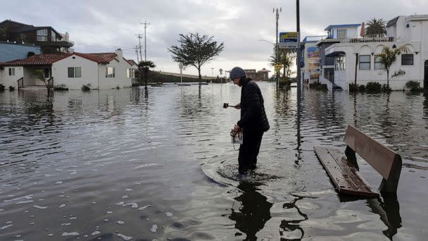PHOTO: FILE - A resident walks along a flooded street, after 'atmospheric river' rainstorms slammed northern California, in the coastal town of Aptos, Jan. 5, 2023. (Carlos Barria/Reuters, FILE)