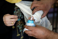 A Jordanian woman puts her finger into an ink bottle after casting her ballot at a polling station for local and municipal elections in Amman, Jordan, August 15, 2017. REUTERS/Muhammad Hamed