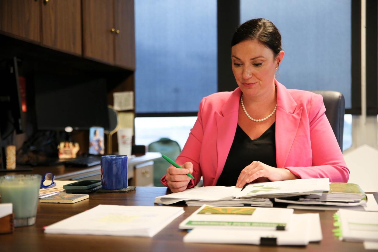 Adria Berry, executive director of the Oklahoma Medical Marijuana Authority, reviews documents June 12 at her office in Oklahoma City.