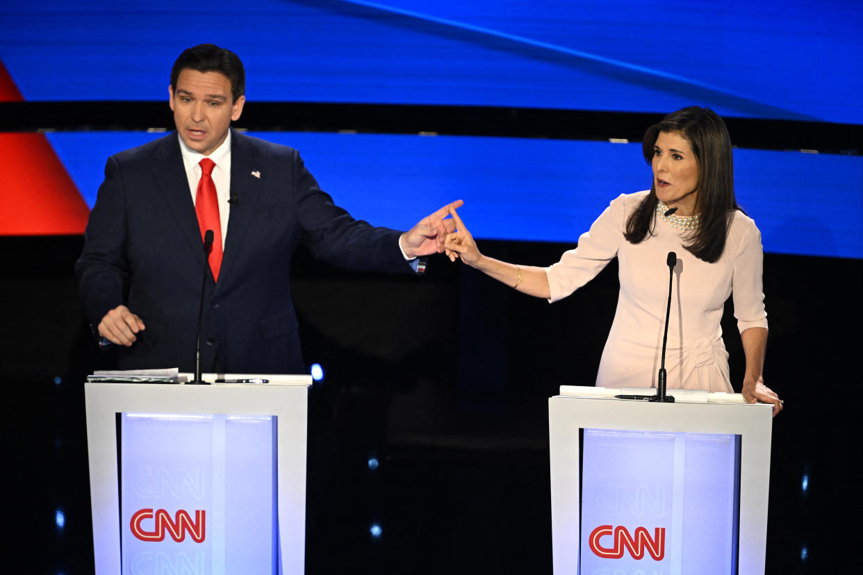 Ron DeSantis and Nikki Haley stand onstage at podiums emblazoned with CNN logo.