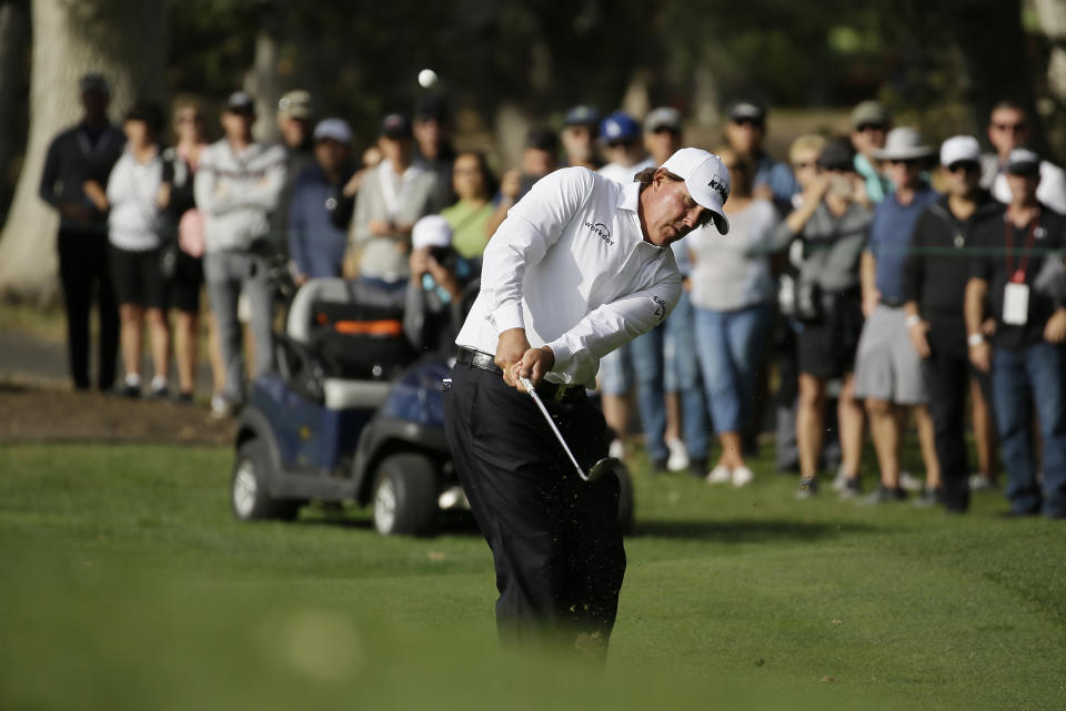 Phil Mickelson chips to the 16th green of the Silverado Resort North Course during the first round of the Safeway Open PGA golf tournament Thursday, Oct. 4, 2018, in Napa, Calif. Mickelson shot a 7-under-par 65. (AP Photo/Eric Risberg)