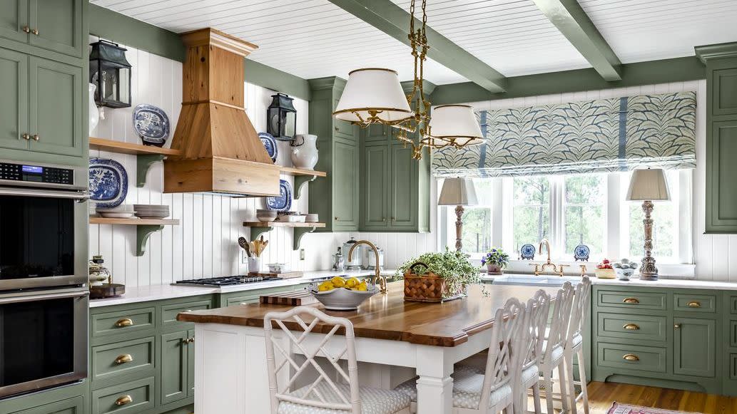 kitchen with soothing green painted cabinets, rafters, and trim paired with white paneled walls, ceiling, and island