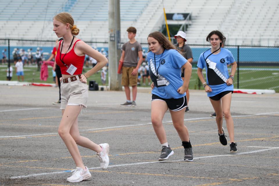 Gibbs band members run through a formation.