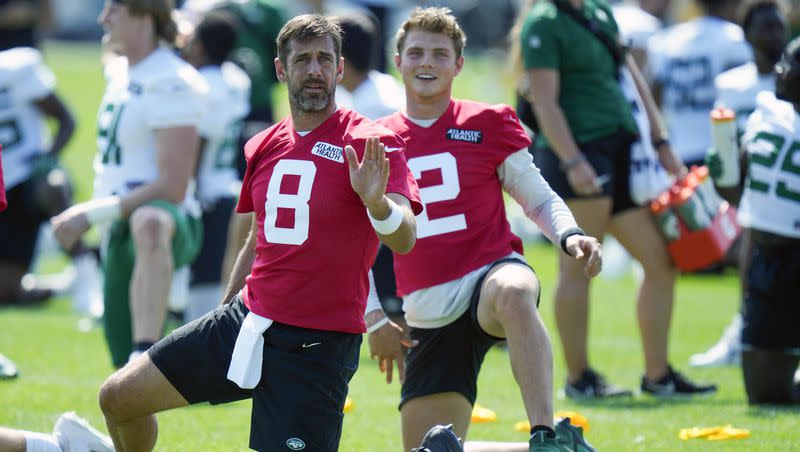 New York Jets quarterbacks Aaron Rodgers, left, and Zach Wilson talk as they stretch at the NFL football team’s training facility in Florham Park, N.J., Sunday, July 23, 2023. Rodgers is the central focus of the first episode of this season’s “Hard Knocks,” which premiered Tuesday, while Wilson is a secondary storyline in the episode.