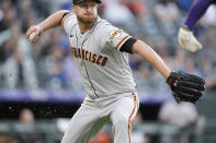 San Francisco Giants starting pitcher Alex Cobb throws to first base to put out Colorado Rockies' Ryan McMahon in the second inning of a baseball game Tuesday, May 17, 2022, in Denver. (AP Photo/David Zalubowski)