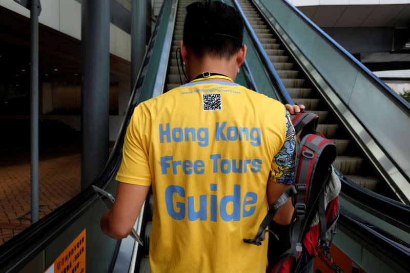 Tour guide Michael Tsang leads a free tour at Admiralty district in Hong Kong