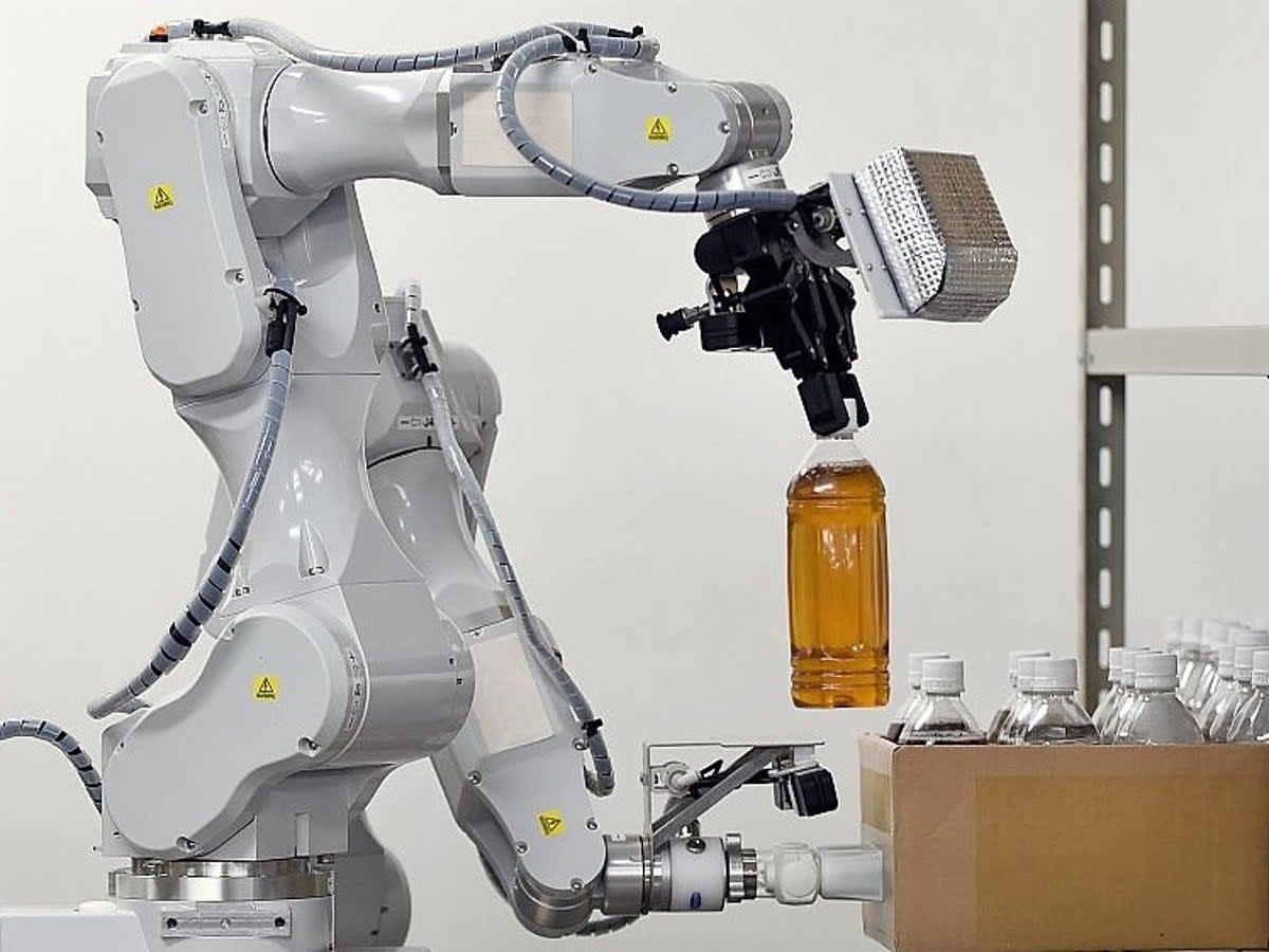 Companies are spending millions on robots like this Hitachi machine pictured in a warehouse in Noda, in suburban Tokyo, on 25 August, 2015 (AFP via Getty Images)