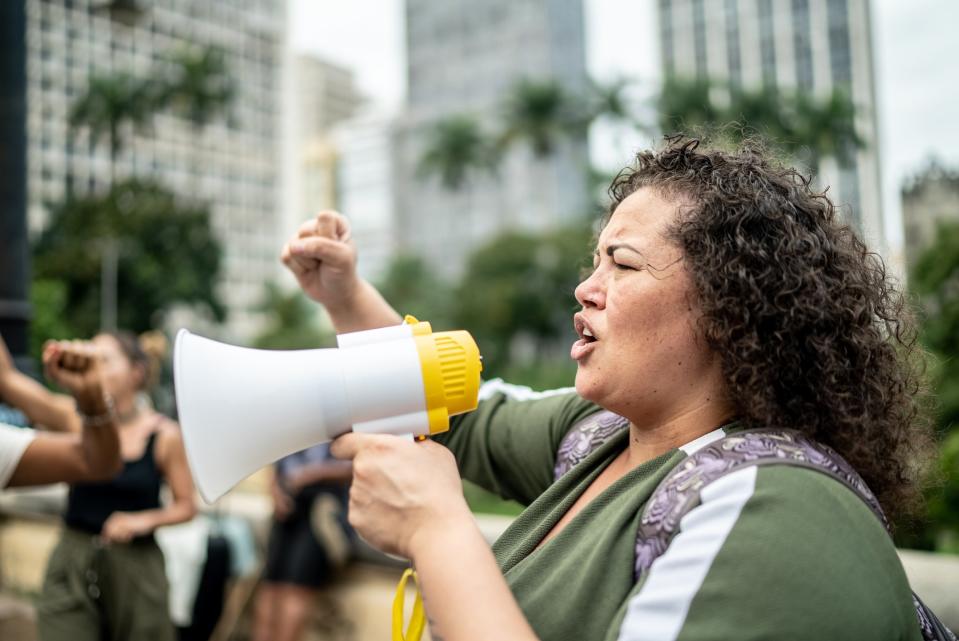 Woman leading protests on a demonstration for equal rights - Copyright: FG Trade/Getty