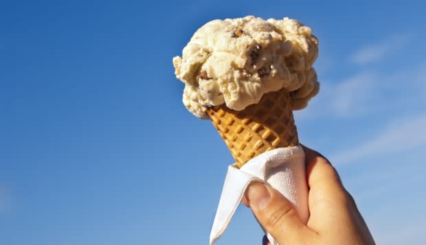 ice cream cone held up to the...