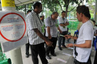 Volunteers helping residents of Punggol East cast their ballots at one several polling stations in the estate.