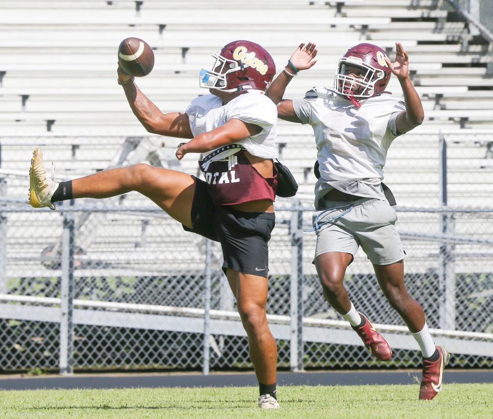 RB Kayleb Wagner leaps for the ball in front of DB Brayshawn Baker during a Baker Gators summer football practice.