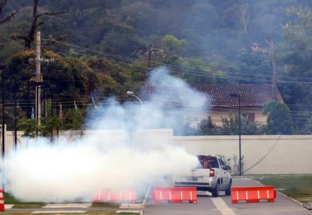 A truck sprays insecticide around Olympic media accomodations as part of preventive measures against the Zika virus and other mosquito-borne diseases, in Rio de Janeiro, Brazil August 29, 2016. REUTERS/Chris Helgren