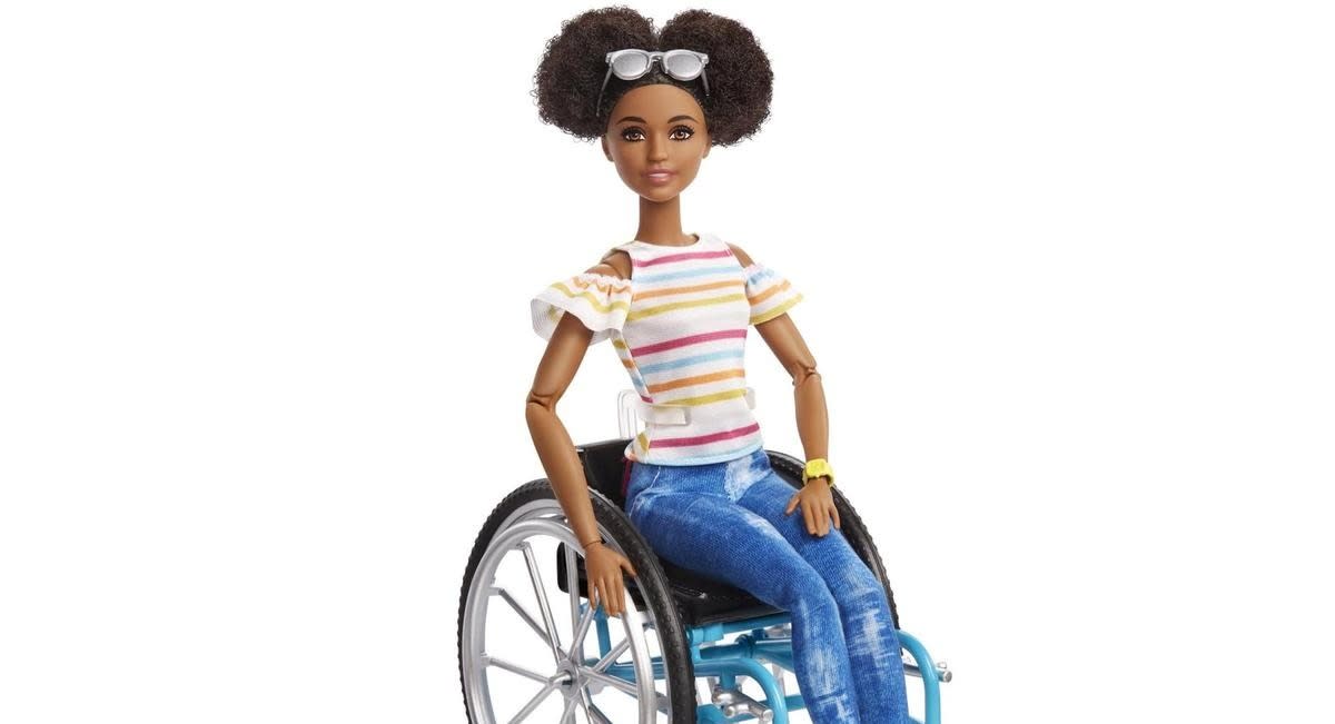 Mattel has created a new black Barbie who wears her hair natural and uses a wheelchair [Image: Mattel]