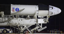 FILE - In this Thursday, May 21, 2020 file photo, a SpaceX Falcon 9 rocket with the company's Crew Dragon spacecraft is rolled out of the horizontal integration facility at Launch Complex 39A as preparations continue for the Demo-2 mission at NASA's Kennedy Space Center in Cape Canaveral, Fla. (Bill Ingalls/NASA via AP)