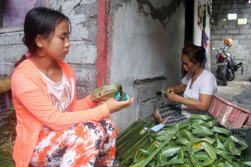 Ni Luh Nael, 13-years-old, helps her grandmother after dropping out of school the during coronavirus disease (COVID-19) pandemic in Denpasar