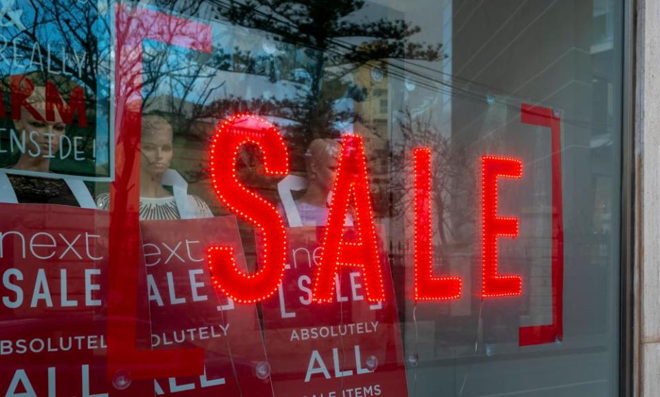 A sale sign adorns a shop window.