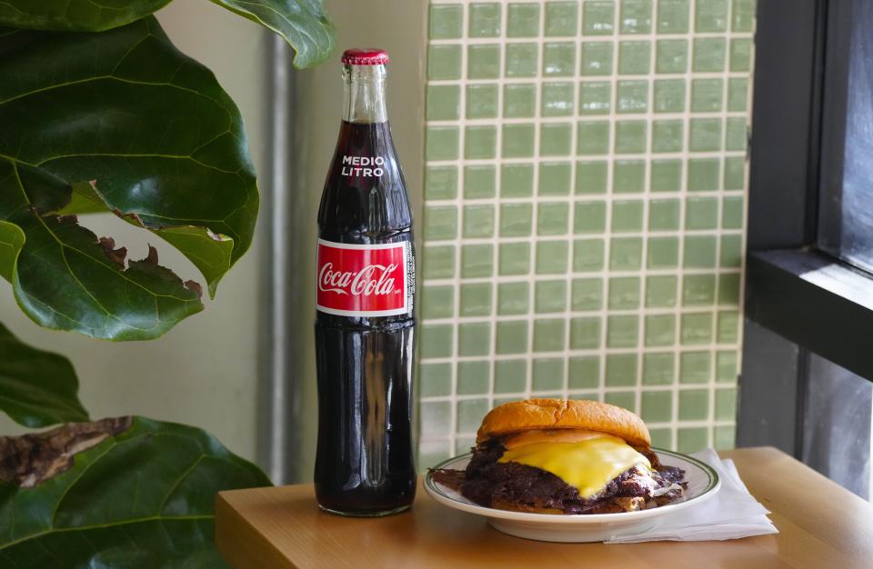 A double burger and a Coke on a counter at Bad Jimmy's in Phoenix on Nov. 28, 2023.