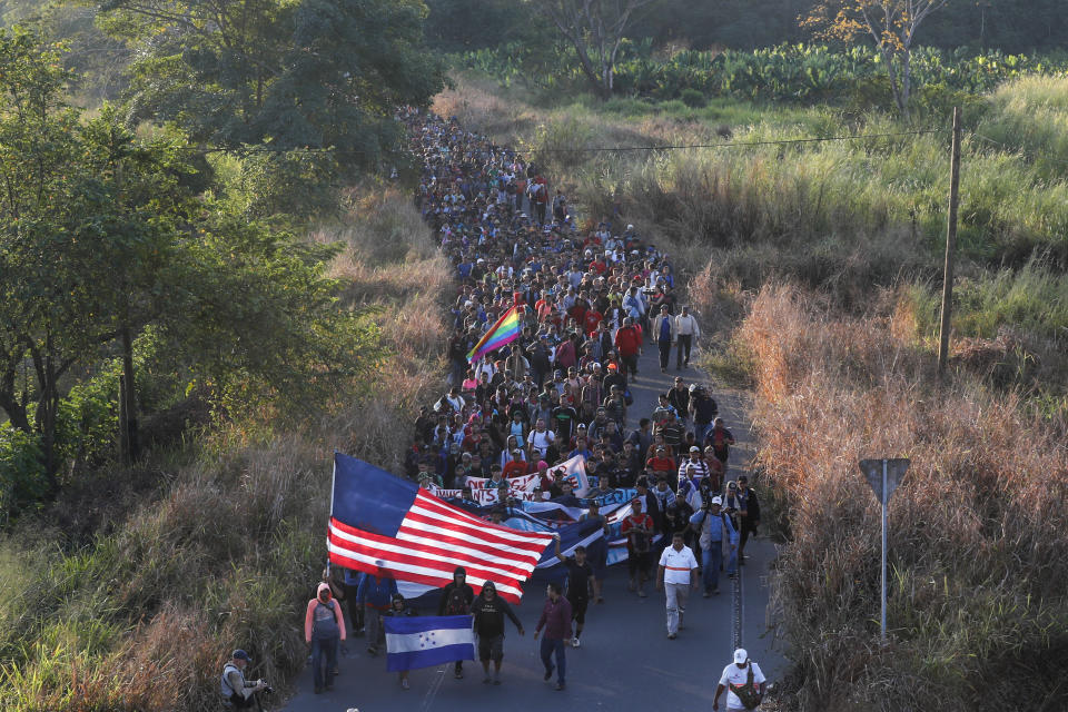 Central American migrants walk carrying a handmade U.S. flag and banners, after crossing the Suchiate River from Guatemala in Ciudad Hidalgo, Mexico, Thursday, Jan. 23, 2020. Hundreds of Central American migrants hoping to reach the United States marooned in Guatemala walked en masse across the river leading to Mexico in a second attempt to convince authorities there to allow them passage through the country. (AP Photo/Marco Ugarte)