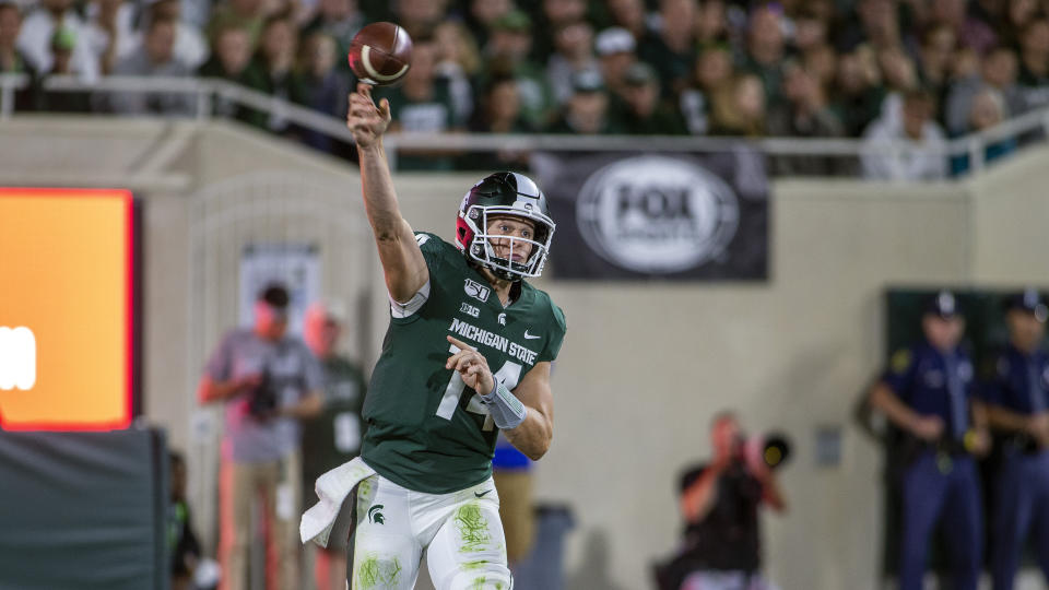 Michigan State quarterback Brian Lewerke (14) throws a pass during the second half of an NCAA football game against Tulsa on Friday, Aug. 30, 2019 in East Lansing, Mich. Michigan State won 28-7. (AP Photo/Tony Ding)