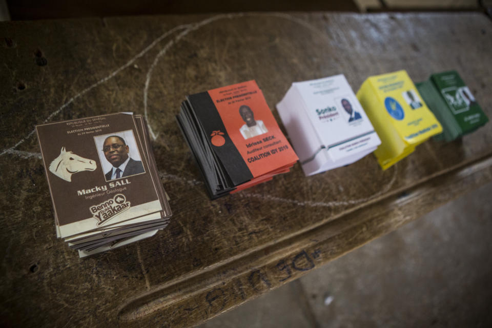 Voting cards are set on a table in a polling station in Dakar, Senegal Sunday Feb. 24, 2019. Voters are choosing whether to give President Macky Sall a second term in office as he faces four challengers.(AP Photo/Jane Hahn)
