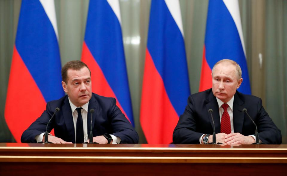 Russian President Vladimir Putin, right, and Prime Minister Dmitry Medvedev meet with members of the government in Moscow on Jan. 15, 2020.