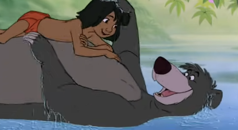 Mowgli lying on the bear's tummy