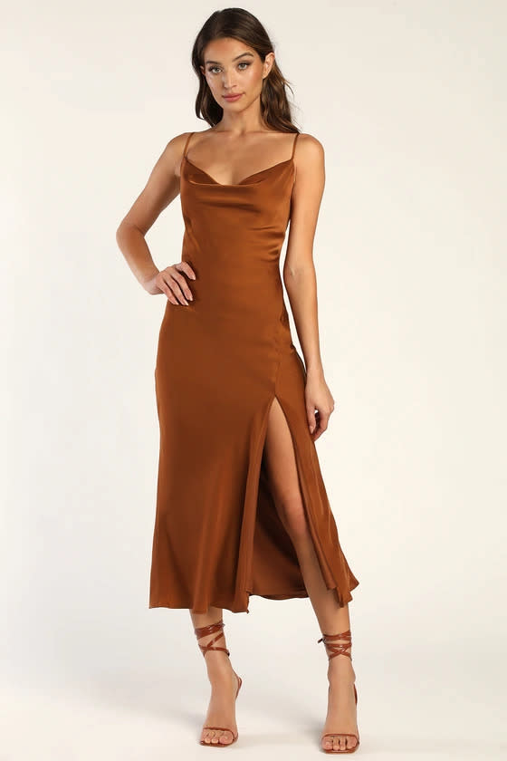 woman wears Romance Starter Brown Satin Cowl Neck Midi Slip Dress. 