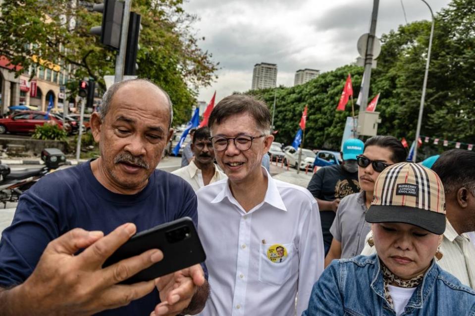 Tian Chua takes a selfie with a supporter during an election campaign in Sentul, November 11, 2022. — Picture by Firdaus Latif