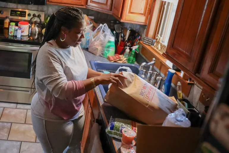 Margaret Benton, 48, unloads groceries obtained from the Sun Prairie Emergency Food Pantry on April 9 at her home in Sun Prairie. The mother of eight children, Benton has relied both on FoodShare, Wisconsin’s government food assistance program, and on charitable organizations such as food pantries for many years. While she understands some people feel stigma for using food assistance, Benton has never been ashamed. “This is why our community has stuff like this,” she says, “to help us in times of need.”