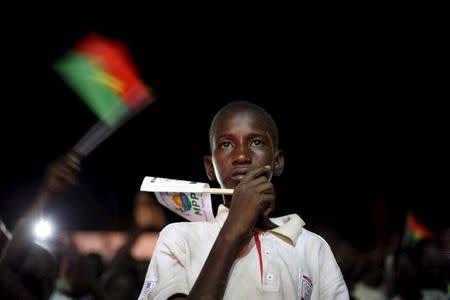 A young supporter of President-elect Roch Marc Kabore watches election results at Kabore's campaign headquarters in Ouagadougou, December 1, 2015. REUTERS/Joe Penney
