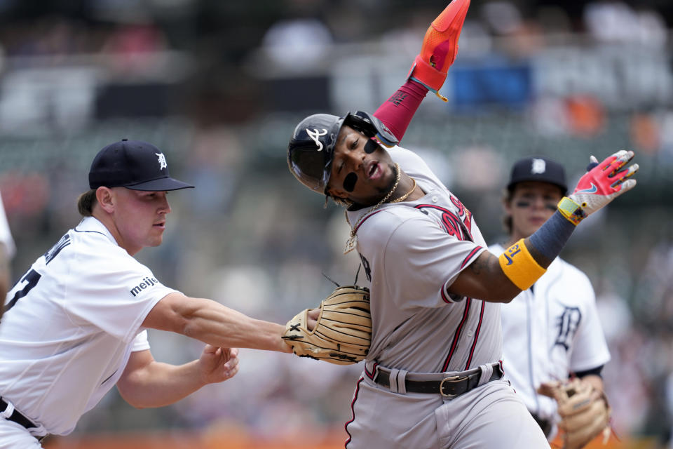 Detroit Tigers relief pitcher Tyler Holton, left, tags out Atlanta Braves' Ronald Acuna Jr., right, in a rundown at second base in the fourth inning during the first baseball game of a doubleheader, Wednesday, June 14, 2023, in Detroit. (AP Photo/Paul Sancya)