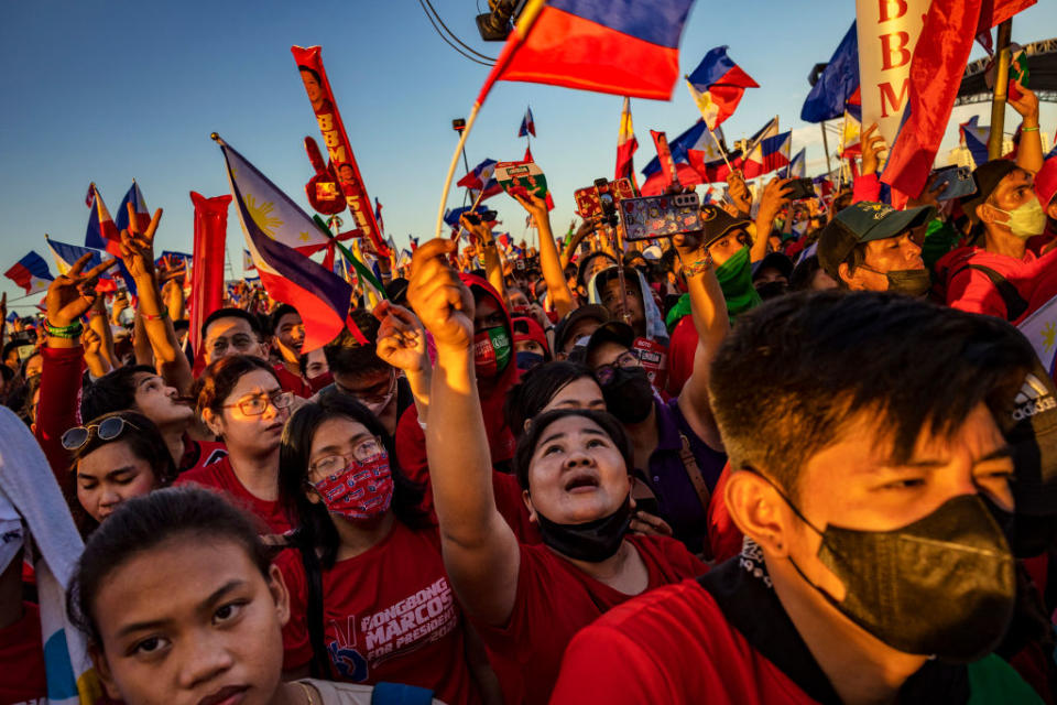 Supporters of Ferdinand "Bongbong" Marcos Jr. and running mate Sara Duterte cheer during their last campaign rally before the election on May 07, 2022 in Paranaque, Metro Manila, Philippines.<span class="copyright">Ezra Acayan/Getty Images</span>