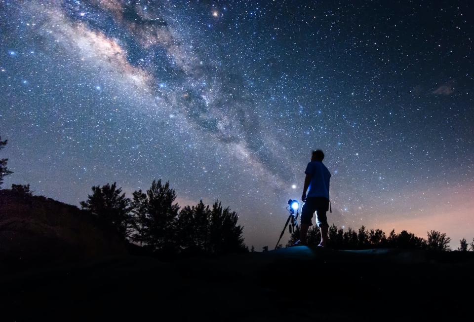 Throughout history, people have looked to the stars to derive some form of meaning from existence. <a href="https://www.gettyimages.com/detail/photo/silhouette-man-standing-against-star-field-royalty-free-image/956508114?adppopup=true" rel="nofollow noopener" target="_blank" data-ylk="slk:Christianto Soning/EyeEm via Getty Images;elm:context_link;itc:0;sec:content-canvas" class="link ">Christianto Soning/EyeEm via Getty Images</a>