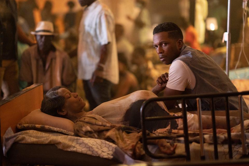 Victor (Leslie Odom, Jr.) cares for his injured pregnant wife Sorenne (Tracey Graves) after a deadly Haitian earthquake in "The Exorcist: Believer."