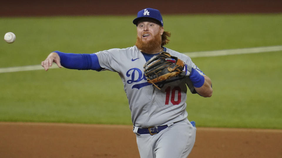 Los Angeles Dodgers' Justin Turner fields a ground out by San Diego Padres' Manny Machado during the third inning in Game 3 of a baseball National League Division Series Thursday, Oct. 8, 2020, in Arlington, Texas. (AP Photo/Sue Ogrocki)