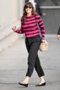 Liv Tyler flashes a smile as she steps out in L.A. on Tuesday wearing a pink-and-black striped sweater, black trousers and flats.