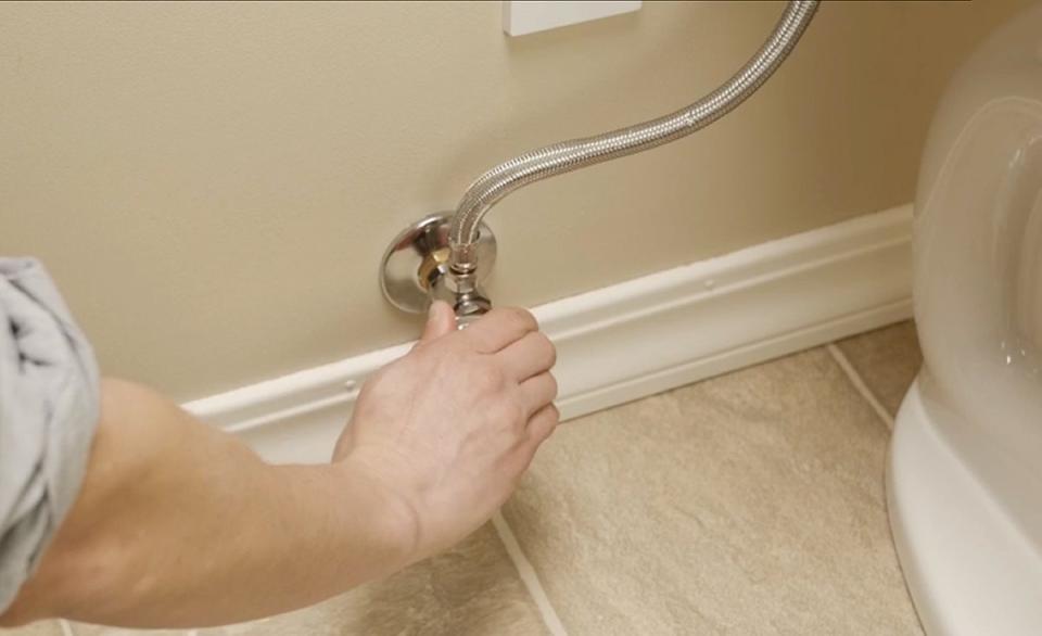 Person turning water supply off