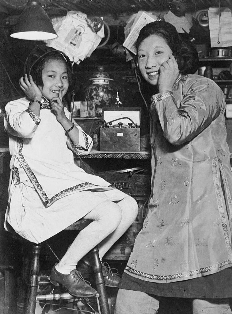 Two sisters in San Francisco's Chinatown listen to a radio together