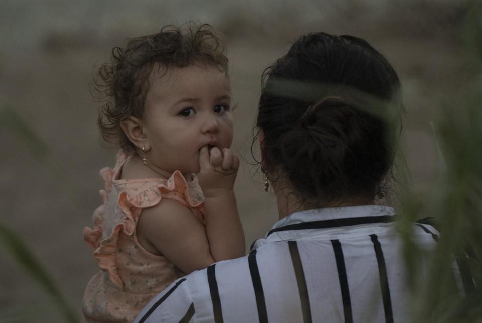 A Colombian mother and her daughter wait to be processed after turning themselves in in Eagle Pass, Texas on July 29, 2023. They crossed through a cap in the concertina wire in the Urbina’s property.
Verónica G. Cárdenas for The Texas Tribune