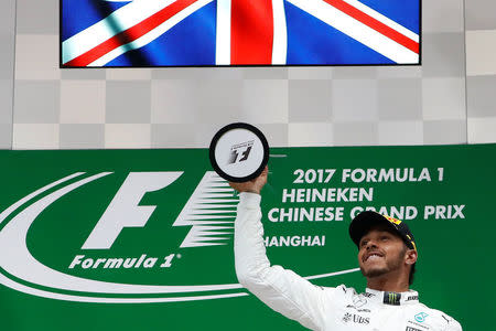 Formula One - F1 - Chinese Grand Prix - Shanghai, China - 09/04/17 - Mercedes driver Lewis Hamilton of Britain celebrates on the podium after winning the Chinese Grand Prix at the Shanghai International Circuit. REUTERS/Aly Song